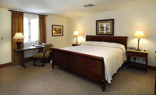 a hotel room with a bed and a desk and a bed sidx sidx sidx sidx at Arizona Inn in Tucson