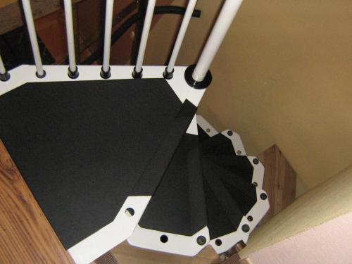 a close up of a stair case with a black and white ramp at Logîte Touristique Les 3 Loups in Châtenois