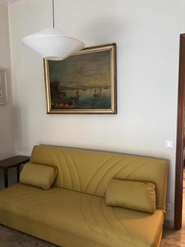a couch in a living room with a painting on the wall at Alloggio Galli in Cremona
