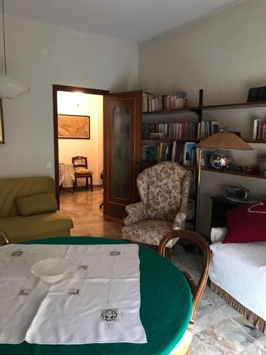 a living room with a table and a chair at Alloggio Galli in Cremona
