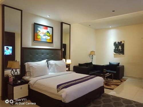 En eller flere senger på et rom på Ayla City Hotel