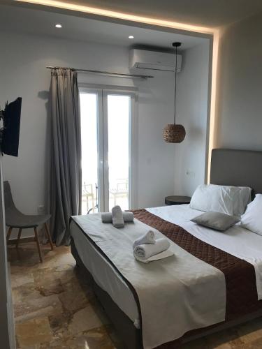 a bedroom with a large bed with towels on it at Kokkinos Villas in Akrotiri
