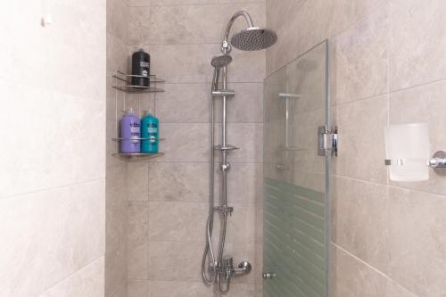 a shower with a shower head in a bathroom at Athens Luxury House in Athens