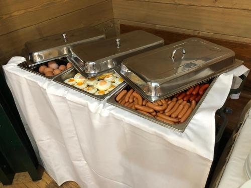 a buffet with eggs and other food on a table at U Medvidku-Brewery Hotel in Prague
