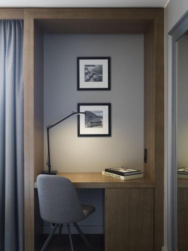 a desk with a chair and a lamp on a wall at Radisson Blu Hotel Bodø in Bodø