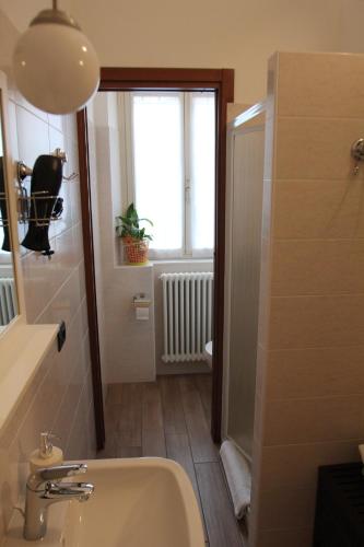 a bathroom with a sink and a window at La Tegola in Como