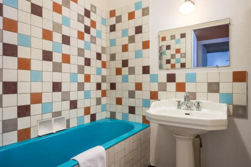 a bathroom with a sink and a bath tub at Honorê - Suite Jacobins in Lyon