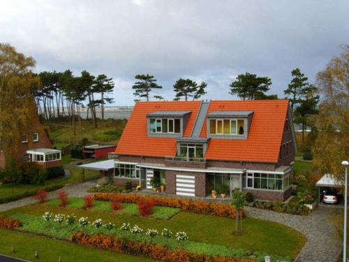 an orange roofed house with a garden at Haus in der Duene _ Objekt 25954 in Warnemünde