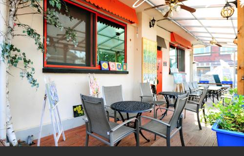 a row of tables and chairs on a patio at Jarasum Guest House in Gapyeong