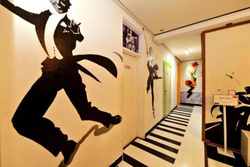 a hallway with a mural of a man on the wall at Jarasum Guest House in Gapyeong