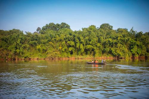 a group of people in a boat on a river at Cat Tien Jungle Lodge in Cat Tien