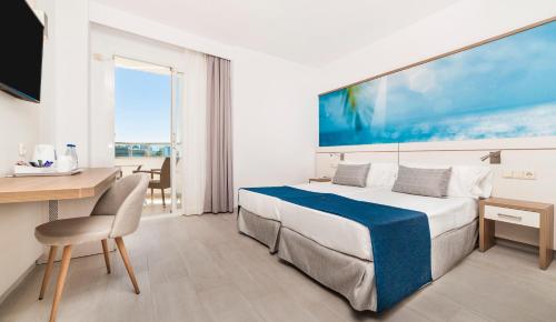 ein Hotelzimmer mit einem Bett, einem Schreibtisch, einem Tisch und einem Stuhl in der Unterkunft Globales Santa Lucia - Adults Only 18 in Palmanova