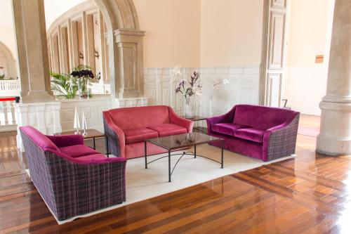 a living room with two chairs and a table at INATEL Palace S.Pedro Do Sul in Termas de Sao Pedro do Sul