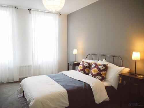 a bedroom with a bed with pillows and a window at Homely Serviced Apartments - Figtree in Sheffield