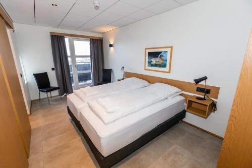 Postel nebo postele na pokoji v ubytování Hrimland Apartments