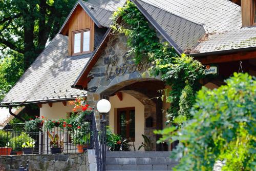 a building with a sign on the side of it at Pension Restaurant Bobrovník in Lipova Lazne