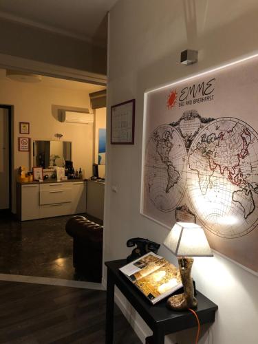 a room with a table with a world map on the wall at Emme B&B in Messina