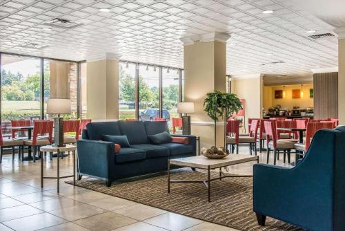 a lobby with a couch and tables and chairs at Comfort Inn Cranberry Twp in Cranberry Township