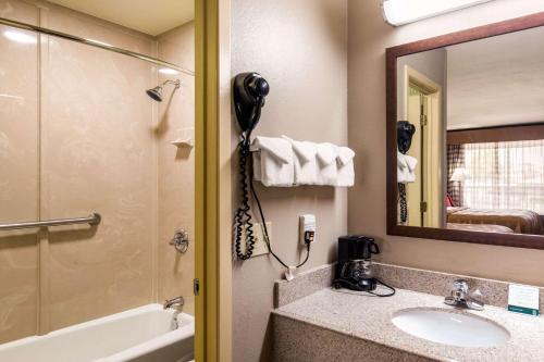 a bathroom with a sink and a mirror and a phone at Quality Inn Paris Texas in Paris