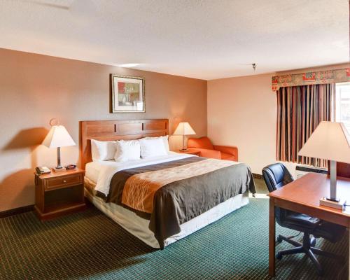 a hotel room with a bed and a desk at Quality Inn in Forest Hill