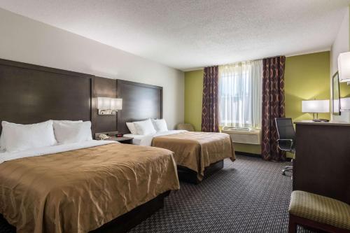 a hotel room with two beds and a window at Quality Inn Warsaw near Rappahannock River in Warsaw