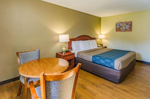 a hotel room with a bed and a table at Econo Lodge Lexington Downtown near I-81 in Lexington