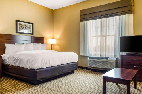 a hotel room with a bed and a television at MainStay Suites Hackberry Sportsman's Lodge in Hackberry