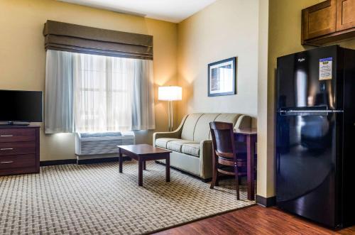 a living room with a couch and a table at MainStay Suites Hackberry Sportsman's Lodge in Hackberry