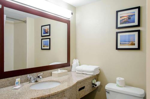 a bathroom with a sink and a mirror and a toilet at Comfort Inn & Suites Biloxi-D'Iberville in Biloxi