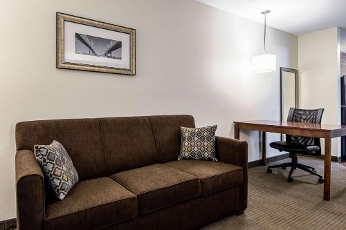 a living room with a couch and a table at MainStay Suites Geismar - Gonzales in Geismar
