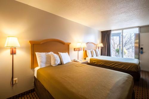 a hotel room with two beds and a window at Econo Lodge Elkridge near Arundel Mills in Elkridge