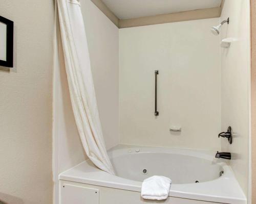 a white bathroom with a tub and a shower at Comfort Inn Livingston in Livingston