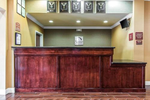 a large wooden bar in a hospital lobby at Sleep Inn & Suites Huntsville near US Space & Rocket Center in Huntsville