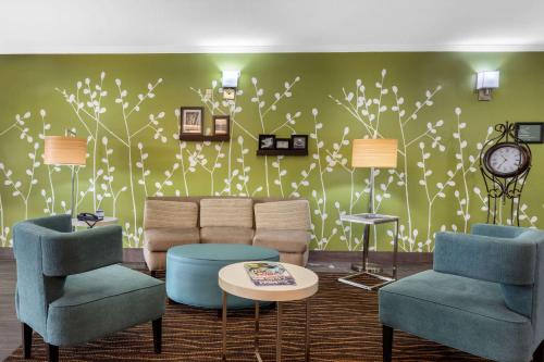 a living room with a couch and two chairs at Sleep Inn & Suites Millbrook - Prattville in Millbrook