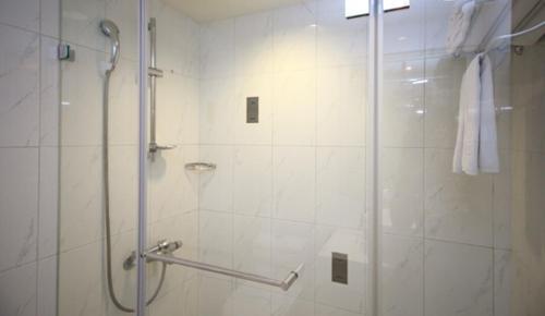a bathroom with a shower with a glass door at Love Hotel in Taipei