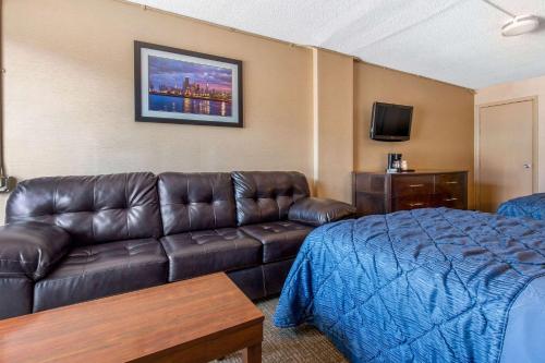 a hotel room with a couch and a bed at Rodeway Inn in Chicago