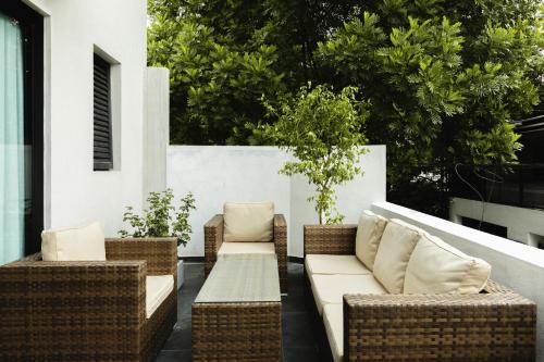 a patio with wicker chairs and a couch at Lavonca Boutique Hotel in Colombo
