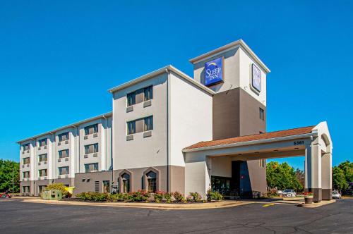 a hotel building with a sign on top of it at Sleep Inn Frederick - Ballenger Creek in Frederick