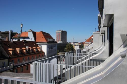 a view of a city from the balcony of a building at Schiller 5 Hotel in Munich