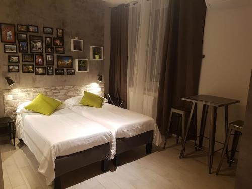 a bedroom with a bed with two lime green pillows at Warrest - Short Rent Apartments in Milan