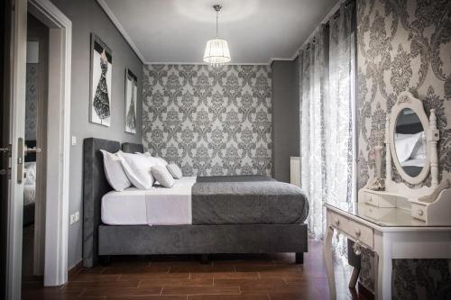 a bedroom with a bed and a mirror at MiLo Luxury House -Free Airport pick up-10min drive in Markopoulo