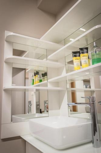 a white bathroom with a sink and a mirror at Villa Nena in Kranjska Gora