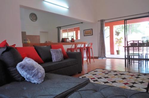 a living room with a couch and a table with chairs at Butterfly Apartments in Livingstone