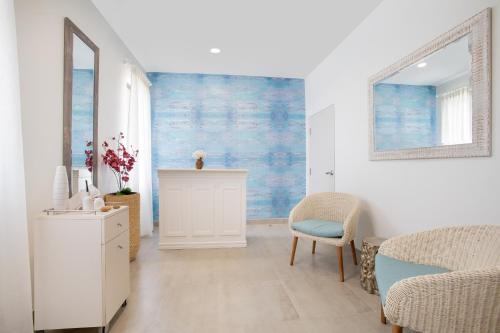 a living room with a blue painting on the wall at Beach View Hotel in Saint James
