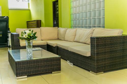 a living room with a couch and a table with flowers at Hotel Rezident in Turčianske Teplice