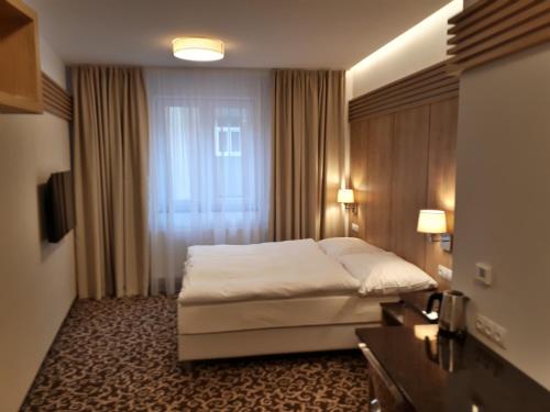 a hotel room with a bed and a window at Urpí­n City Residence in Banská Bystrica