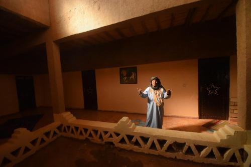 a woman standing in the middle of a room at Family Moroccan House in Merzouga