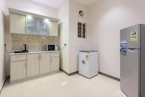 a kitchen with a refrigerator and a sink in a room at Dior Inn Apartment Hotel in Jeddah