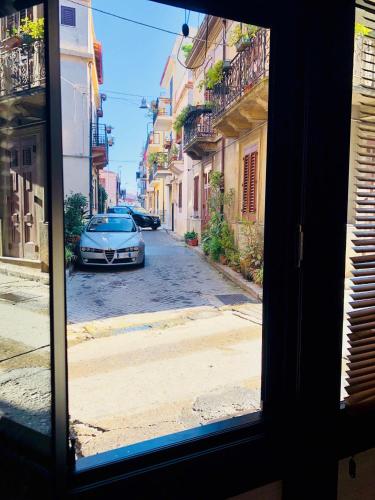 a view from a window of a street with a car at Da Santina in Scilla