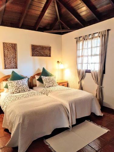 a bedroom with a large bed and a window at Casas rurales LAS TIAS I in Tijarafe
